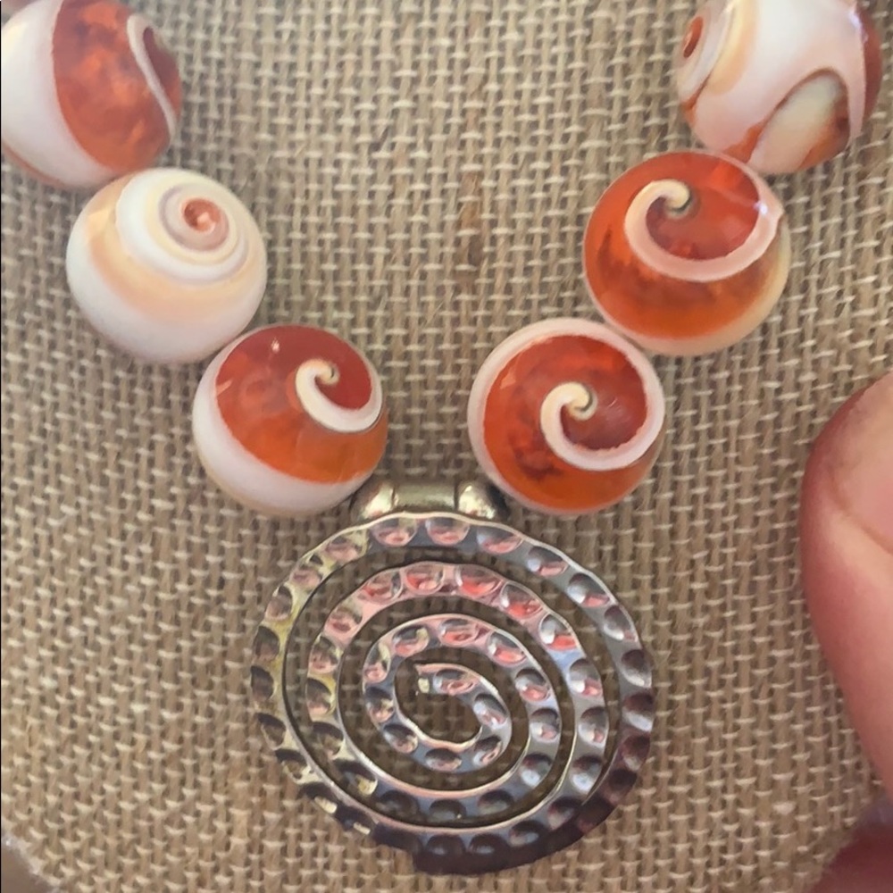Unique necklace with a silver swirl focal